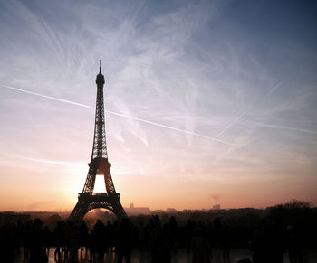 Silhouette people with eiffel tower against sky during sunset