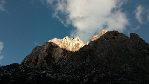 Low angle view of rock formations against sky