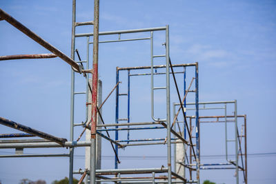 Low angle view of crane against blue sky