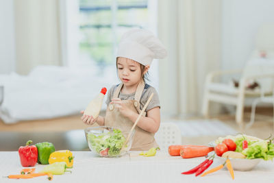 Midsection of woman holding food on table