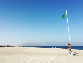 Scenic view of beach against clear blue sky