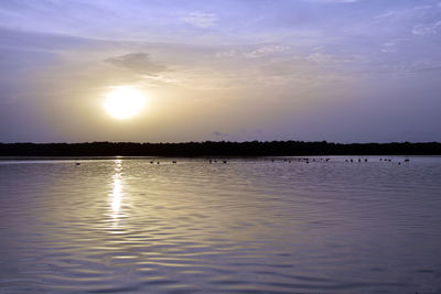 Scenic view of lake against sky during sunset