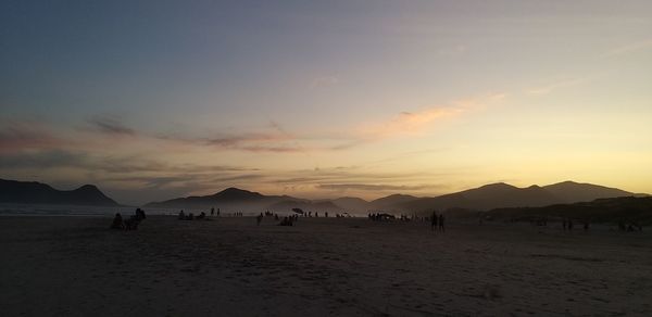 Scenic view of beach against sky during sunset