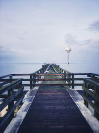 Pier over sea against sky