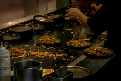 Midsection of person preparing food in kitchen