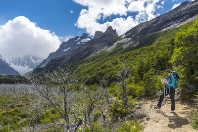 Woman hiking in the andes mountain range towards cerro torre