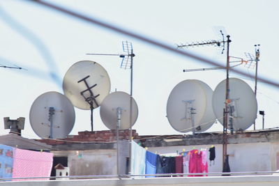 Low angle view disk antenna  satellite against sky