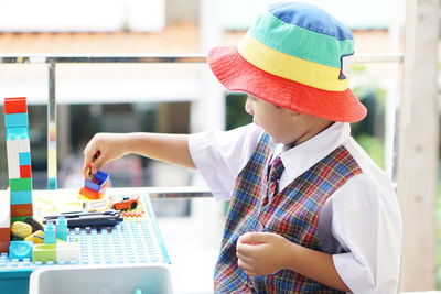 Rear view of boy looking at camera