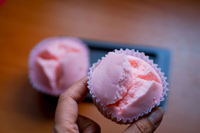 Close-up of hand holding ice cream