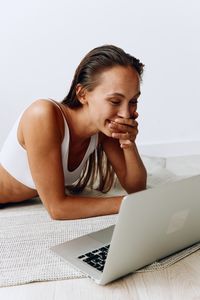 Young woman using laptop at table