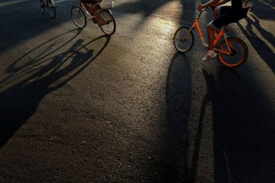 Low section of people riding bicycle on street