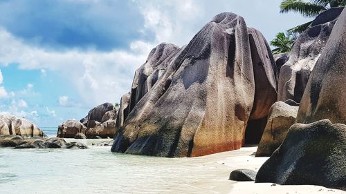 Panoramic view of rocks on beach against sky