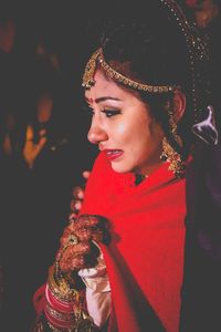 Close-up of bride crying while standing outdoors at night