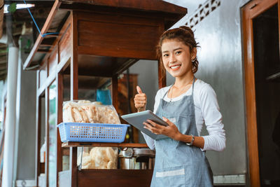 Portrait of young woman using mobile phone