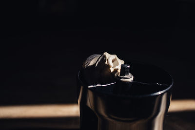 Close-up of cigarette smoking against black background