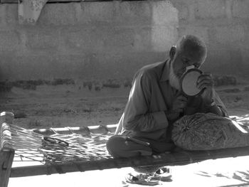 Rear view of a woman sitting outdoors