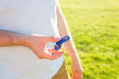 Midsection of woman holding toy