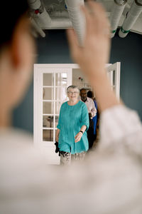 Smiling senior woman and man arriving in dance class