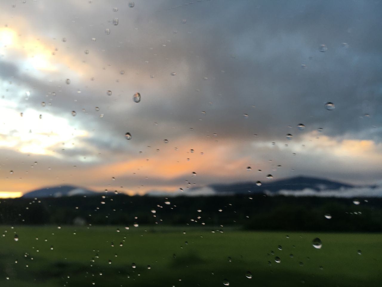 drop, wet, window, water, cloud - sky, sky, transparent, rain, nature, glass - material, no people, sunset, close-up, beauty in nature, focus on foreground, raindrop, full frame, outdoors, rainy season