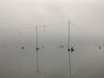 Group of people on cable car against sky