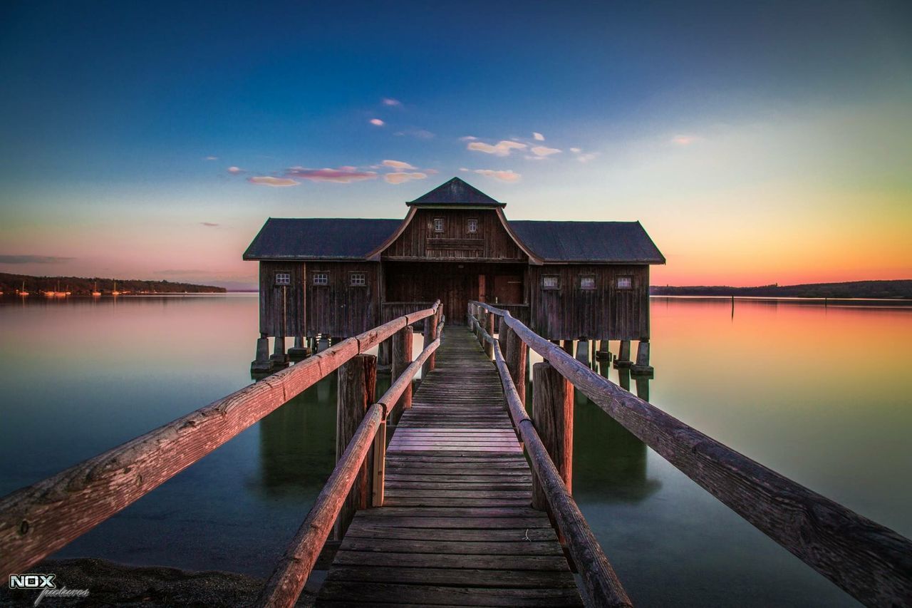 water, pier, built structure, architecture, the way forward, sky, sunset, jetty, sea, tranquility, railing, tranquil scene, wood - material, reflection, scenics, diminishing perspective, beauty in nature, long, nature, building exterior