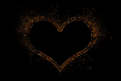 Close-up of heart shape against black background