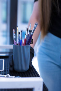Midsection of woman painting on table