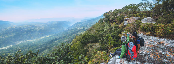 Rear view of woman standing on mountain