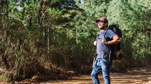 Full length of man standing in forest