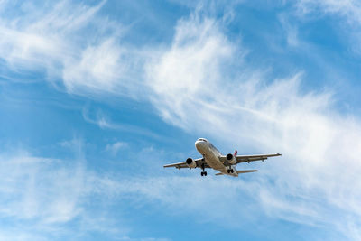 Commercial passenger jet airplane in mid flight, getting ready for landing