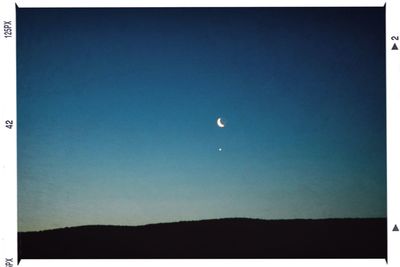 Scenic shot of moon against clear sky at night