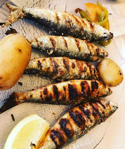 High angle view of fish on barbecue grill