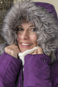 Portrait of smiling woman in fur coat