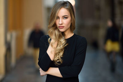 Beautiful young woman standing in city