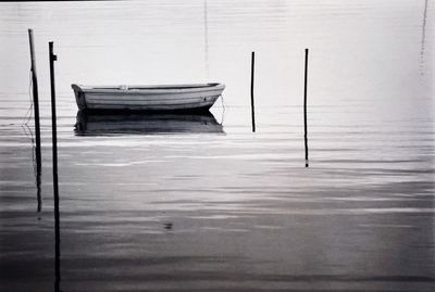 Wooden boat moored in lake