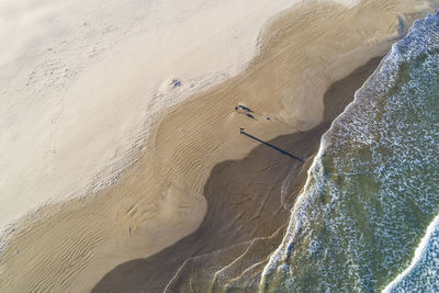 Aerial abstract view of valencia beach with waves and wet sand