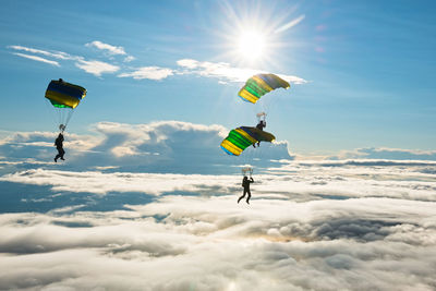 People paragliding against sky