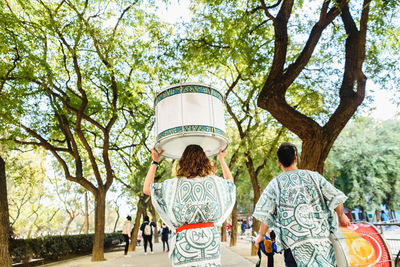 Rear view of people walking in park