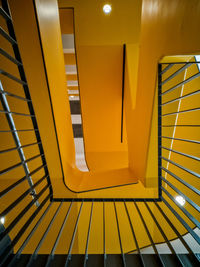 Low angle view of yellow staircase in building