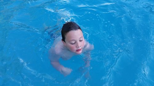 High angle view of boy swimming in pool