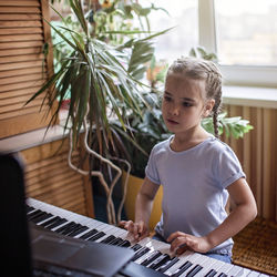 Boy playing with ball sitting at home