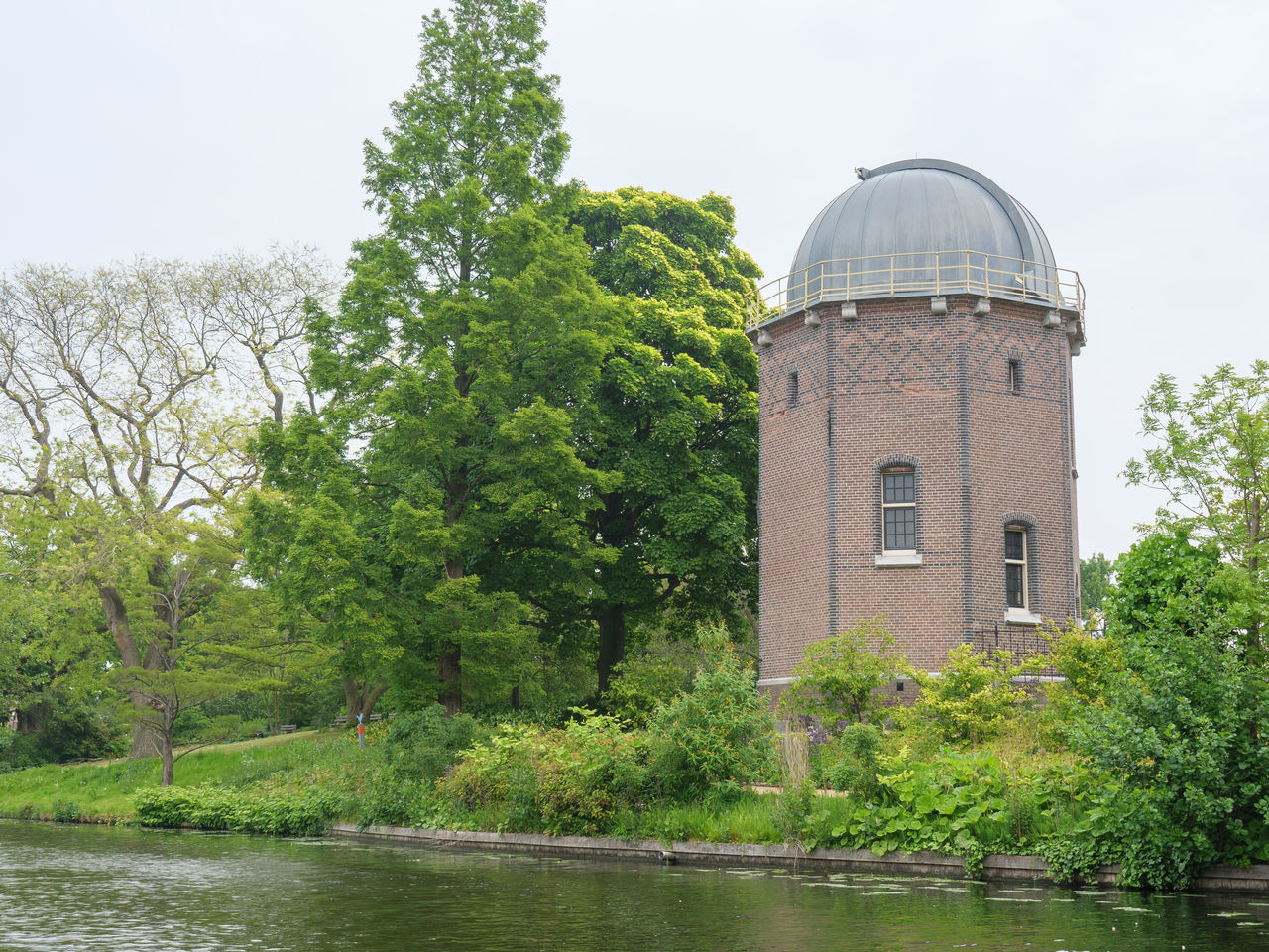 BUILT STRUCTURE BY RIVER AGAINST SKY