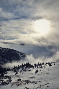 Scenic view of snow covered landscape against sky