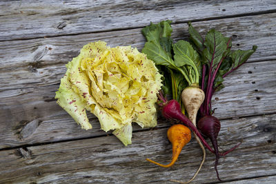 High angle view of radishes and lettuce on table