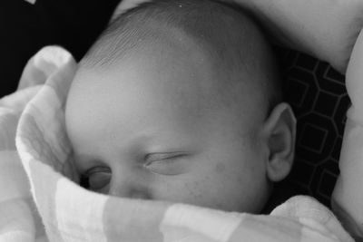 Close-up portrait of cute boy relaxing on bed