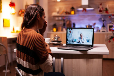 Young woman using laptop at table