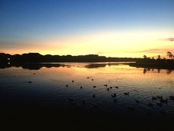 Scenic view of lake at sunset