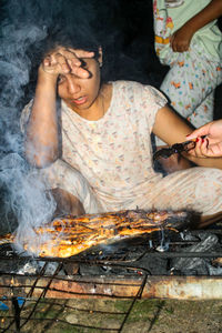 High angle view of man preparing food on barbecue grill