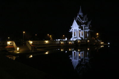 Illuminated building against sky at night
