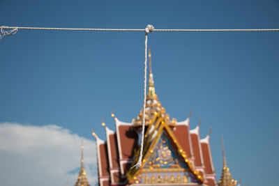 Low angle view of bell tower against blue sky